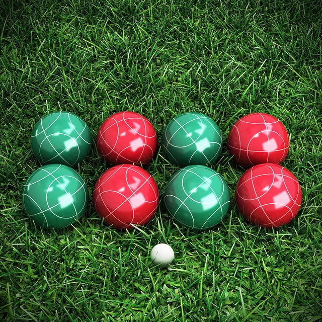 A red and green Bocce ball set on a green lawn.