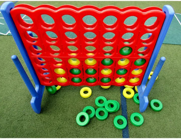 A jumbo sized yard connect game with yellow and green discs.